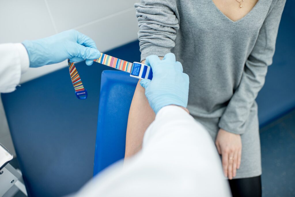 Tightening the harness on the arm for blood extraction